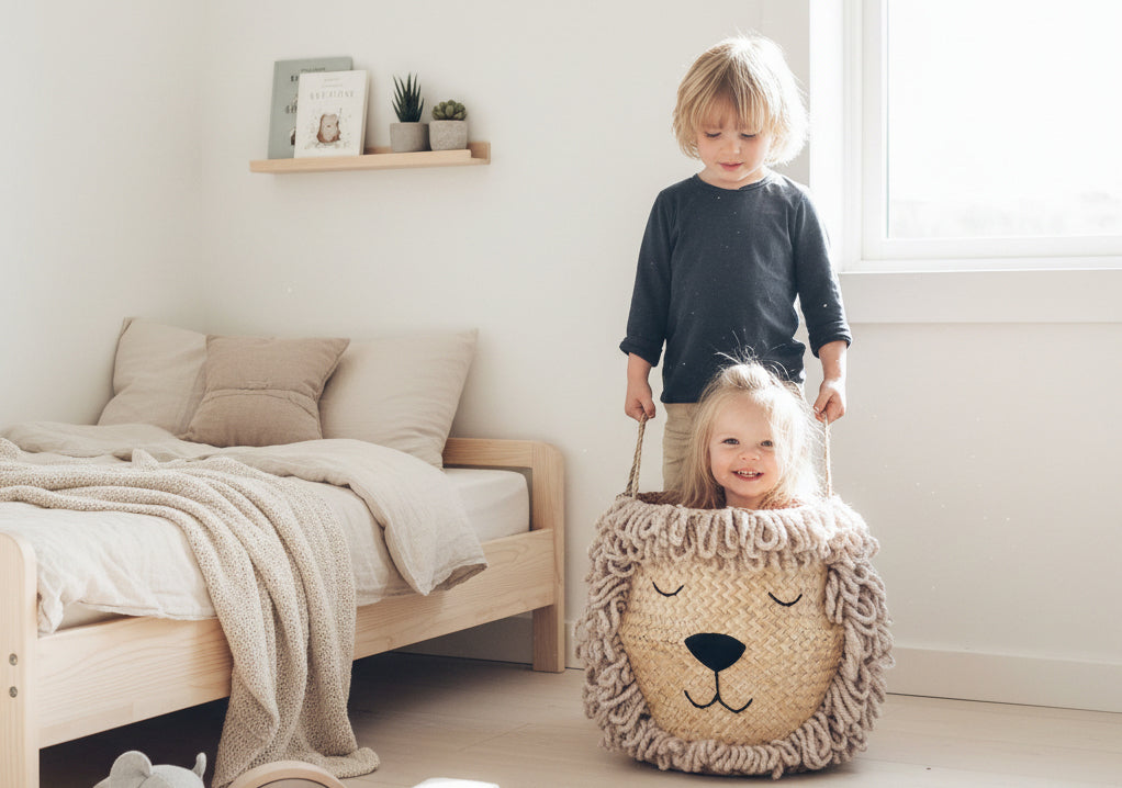 Two young children playing with the Bellybambino Lion basket, hand-tufted wool mane and embroidered face, in a bright family bedroom.