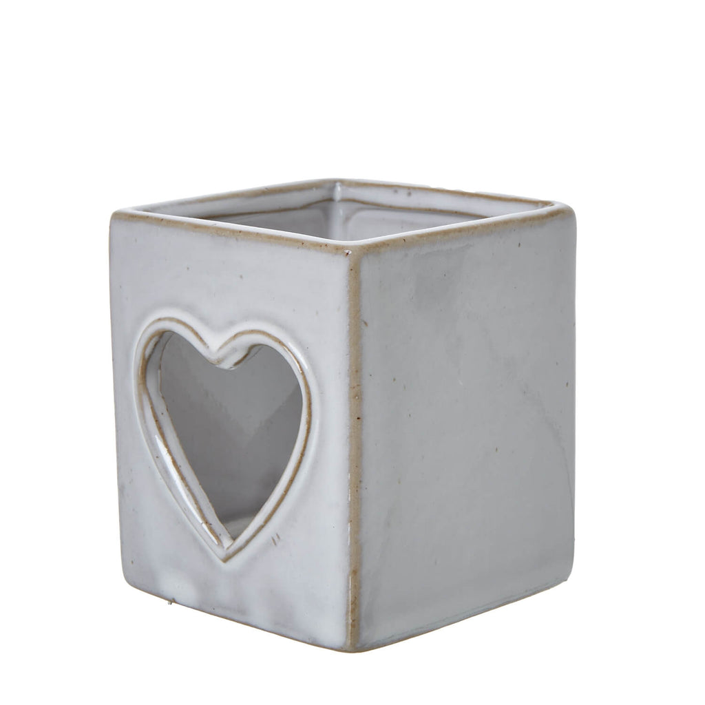 White ceramic tealight holder with heart cutout, Scandinavian design, creates enchanting light patterns by RoomLondon at brixbailey.com