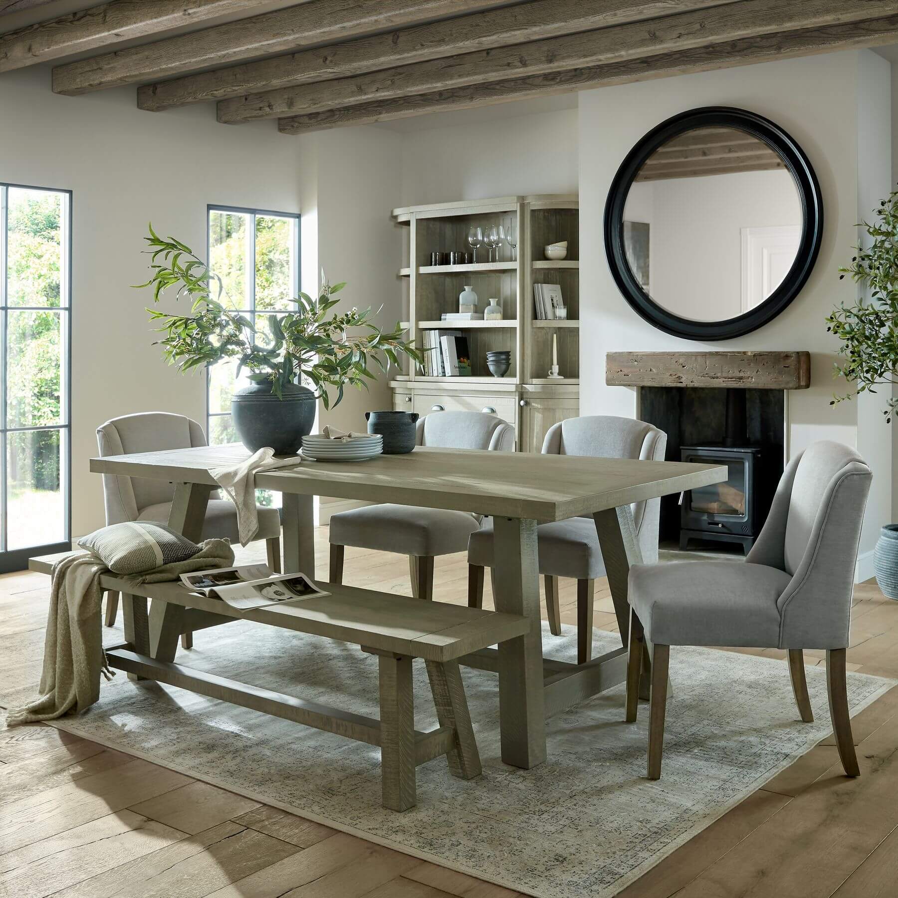 Handcrafted curved pine dining bench in grey-wash finish, seating 3, with rustic-modern design for farmhouse or Scandinavian interiors. by Sostter at brixbailey.com