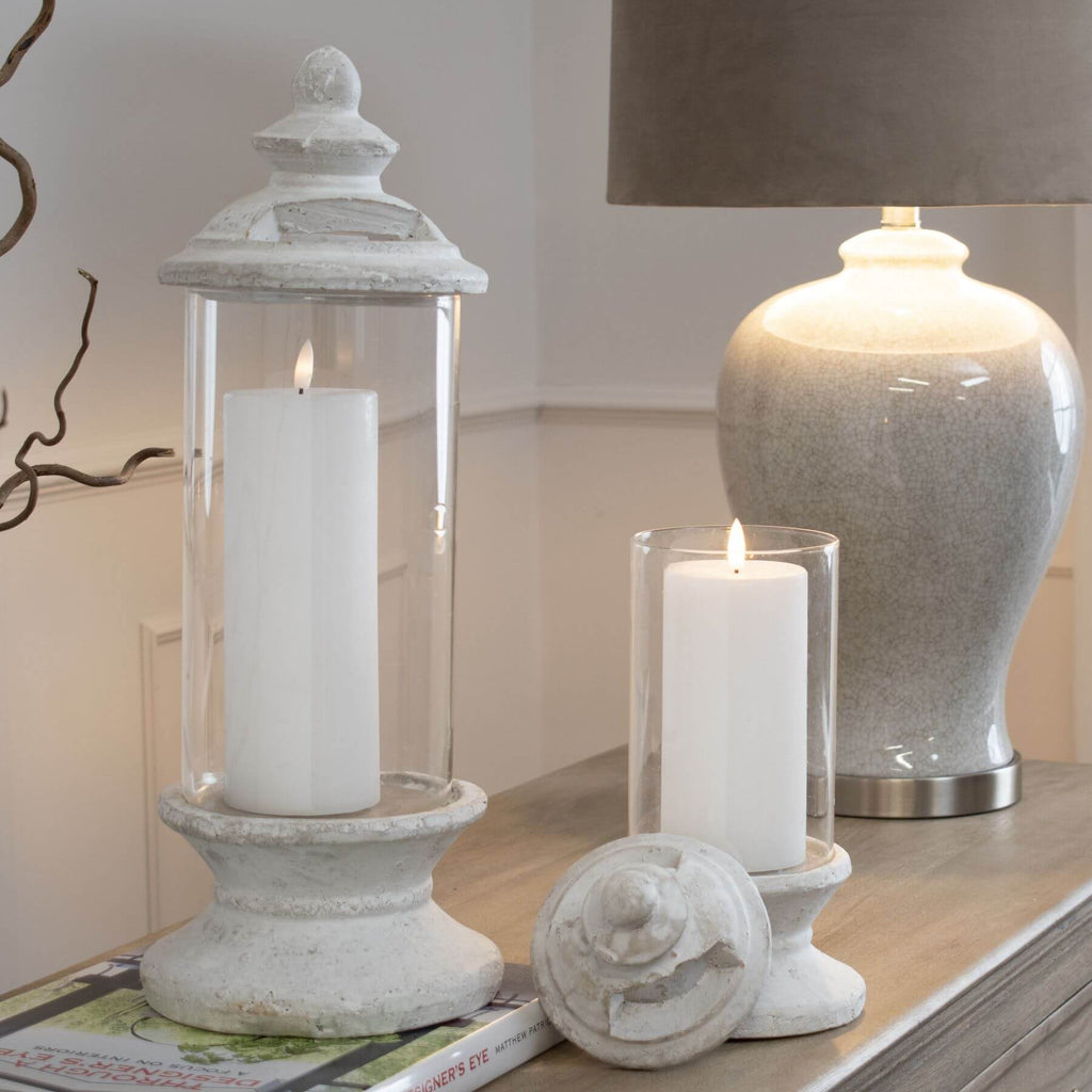 White glass hurricane lantern candle holder with cylindrical design, perfect for LED candles and home decor ambiance. by sostter at brixbailey.com