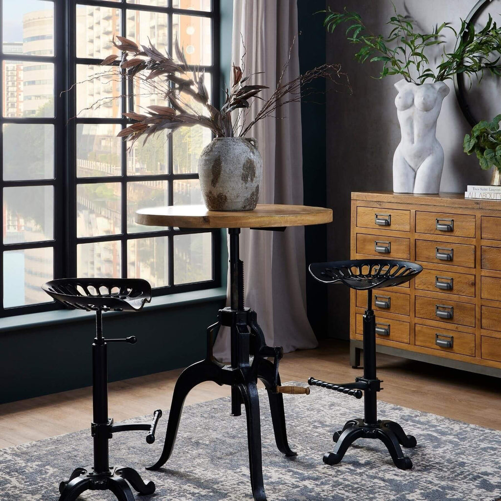 Adjustable industrial bistro table with weathered wood top and black metal frame, perfect for dining or entertaining. by sostter at brixbailey.com