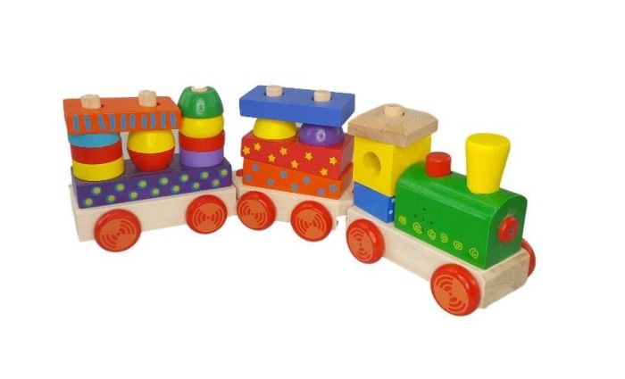 confident toddler playing with a giant wooden block train set that makes realistic engine sounds