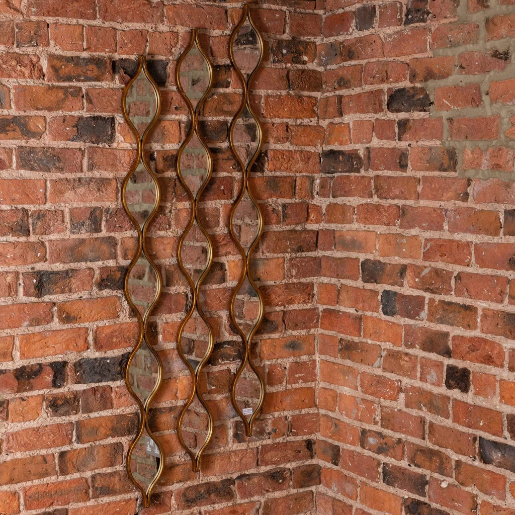 Aged gold-finished glass mirror with warm patina, 146cm tall, enhancing light in modern or traditional interiors. by Sostter at brixbailey.com