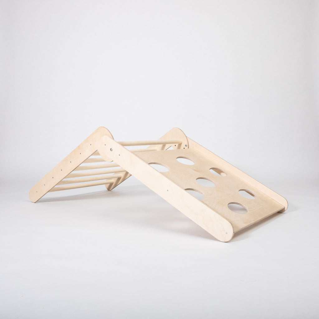 toddler climbing foldable montessori triangle in a sunlit playroom with soft rugs nearby