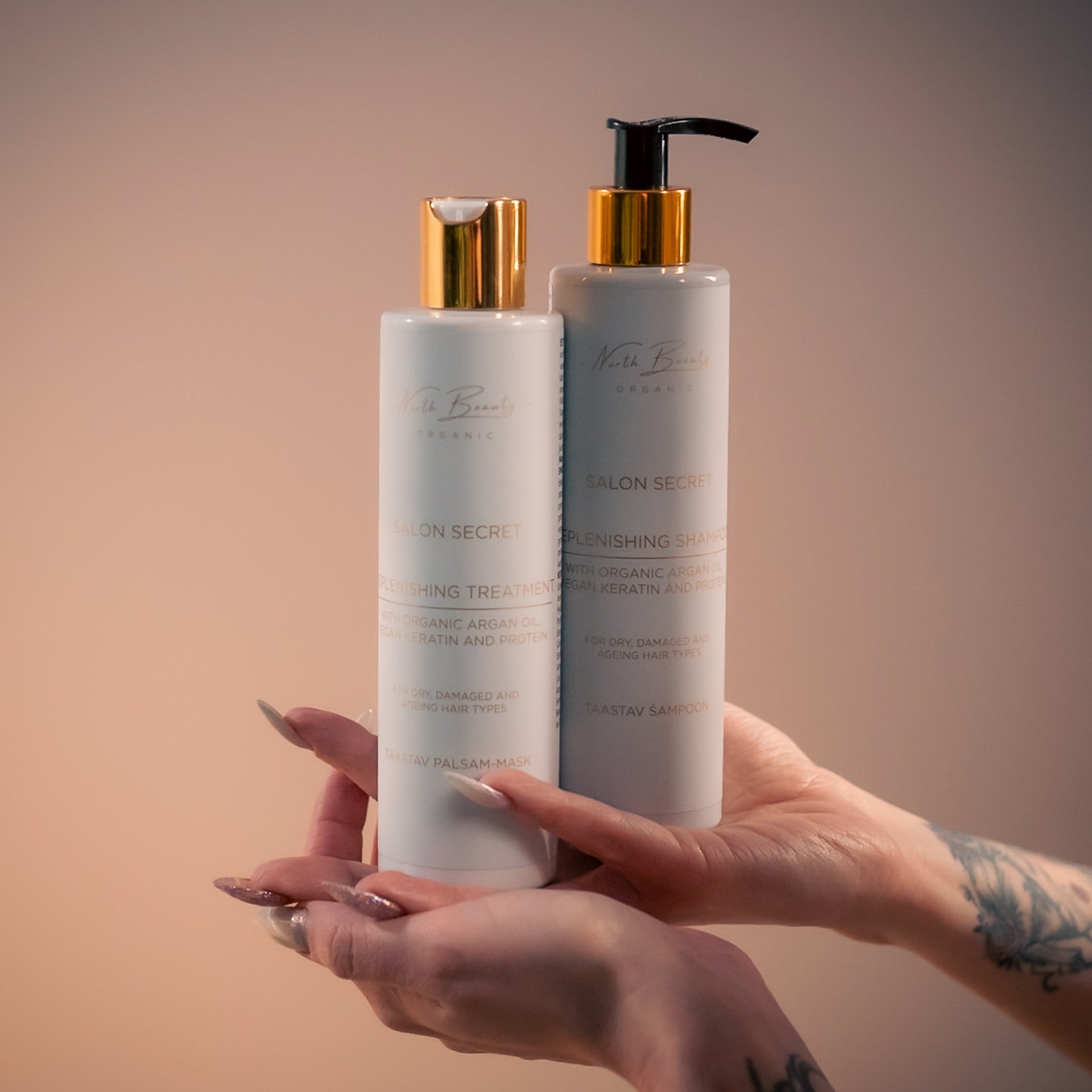 confident woman holding a bottle of restorative hair mask with vegan keratin and argan oil