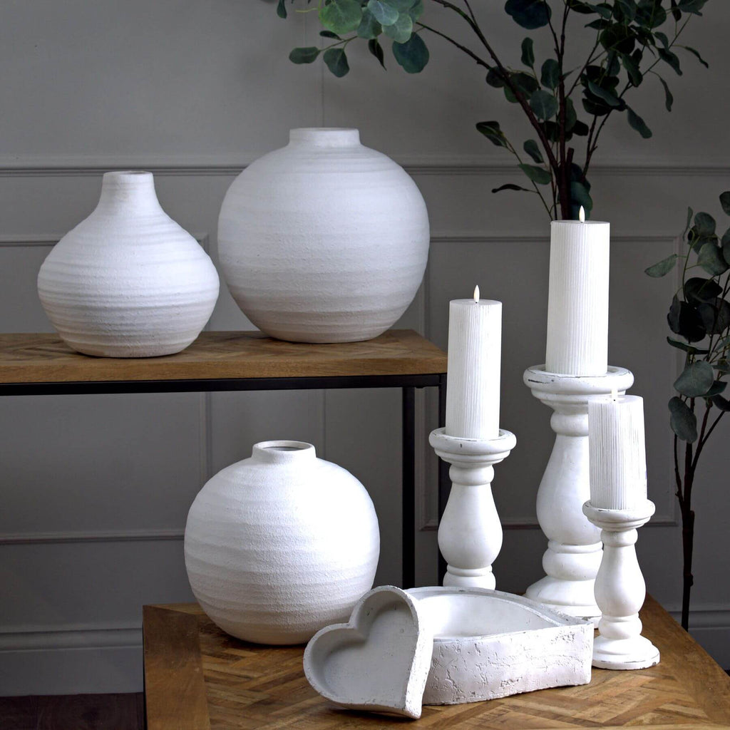 Handcrafted matte white ceramic candle holder with minimalist design for soft light diffusion in home decor. by RoomLondon at brixbailey.com