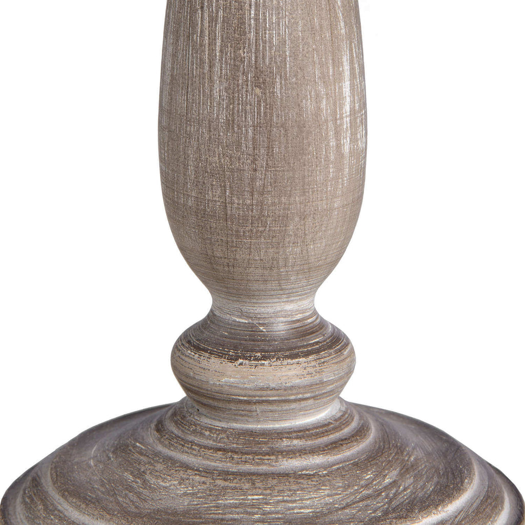 Rustic table lamp with whitewashed wood base and natural linen shade, emitting warm ambient light for cozy home decor. by Sostter at brixbailey.com