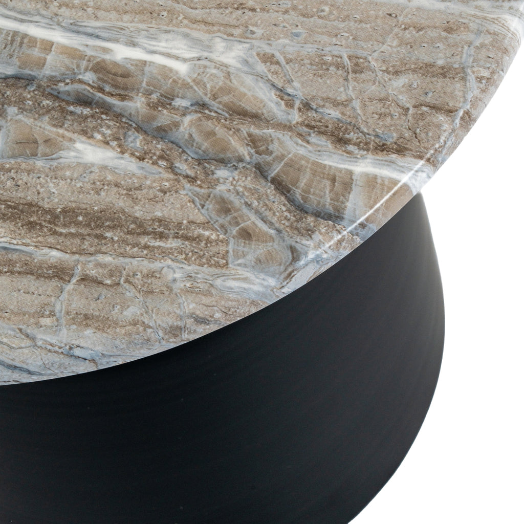 a playful peek at the round black metal table's tapered legs against a bright, airy background