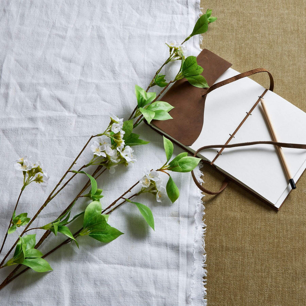 Realistic mock orange spray with glossy green leaves and delicate white petals, 53-inch artificial floral decor by Sostter at brixbailey.com