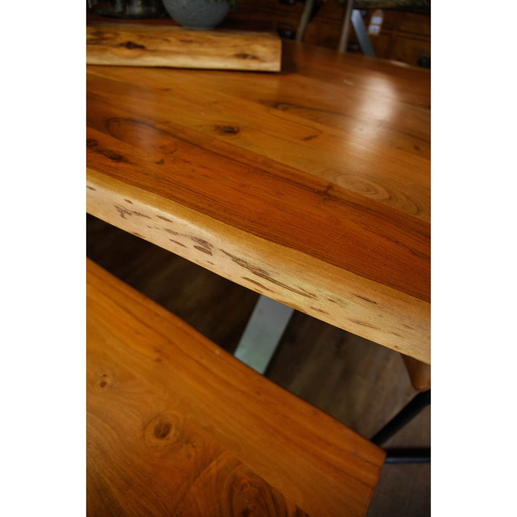 Handcrafted acacia wood live edge dining table with grey metal legs, showcasing natural wood grain and rustic-modern design. by sostter at brixbailey.com