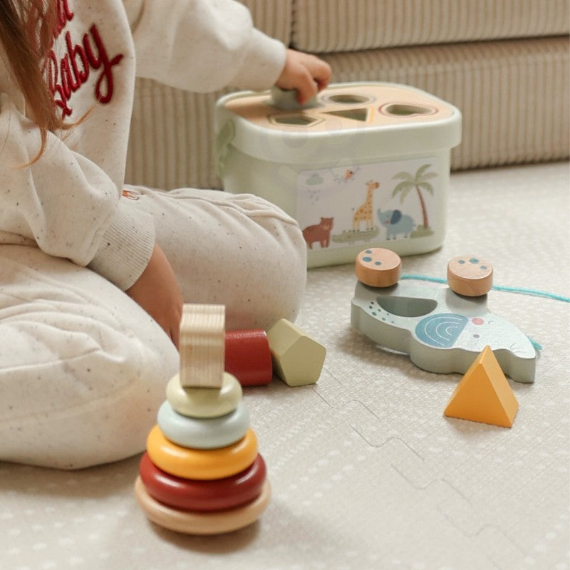 close-up of the stackable pyramid bear with four vibrant discs on a wooden base