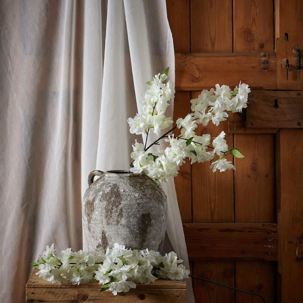 White artificial cherry blossom stem with delicate petals, 100 cm tall, perfect for spring floral arrangements.by Sostter at brixbailey.com