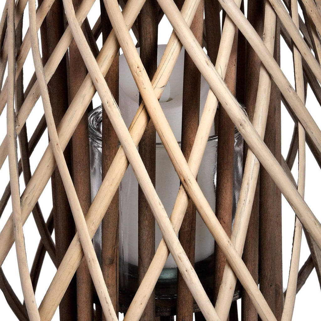 Handwoven rattan lantern with warm brown tones, creating enchanting light patterns for indoor or outdoor decor. by sostter at brixbailey.com
