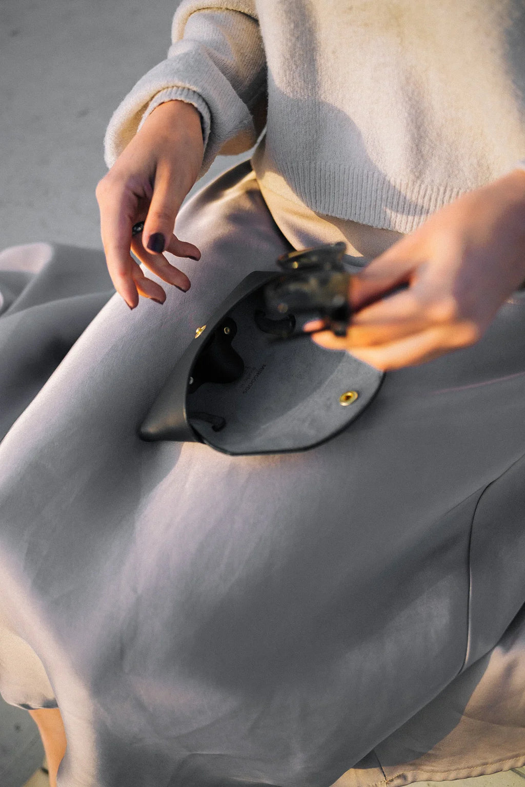 playful close-up of a sleek black leather sunglasses case on a colorful summer towel