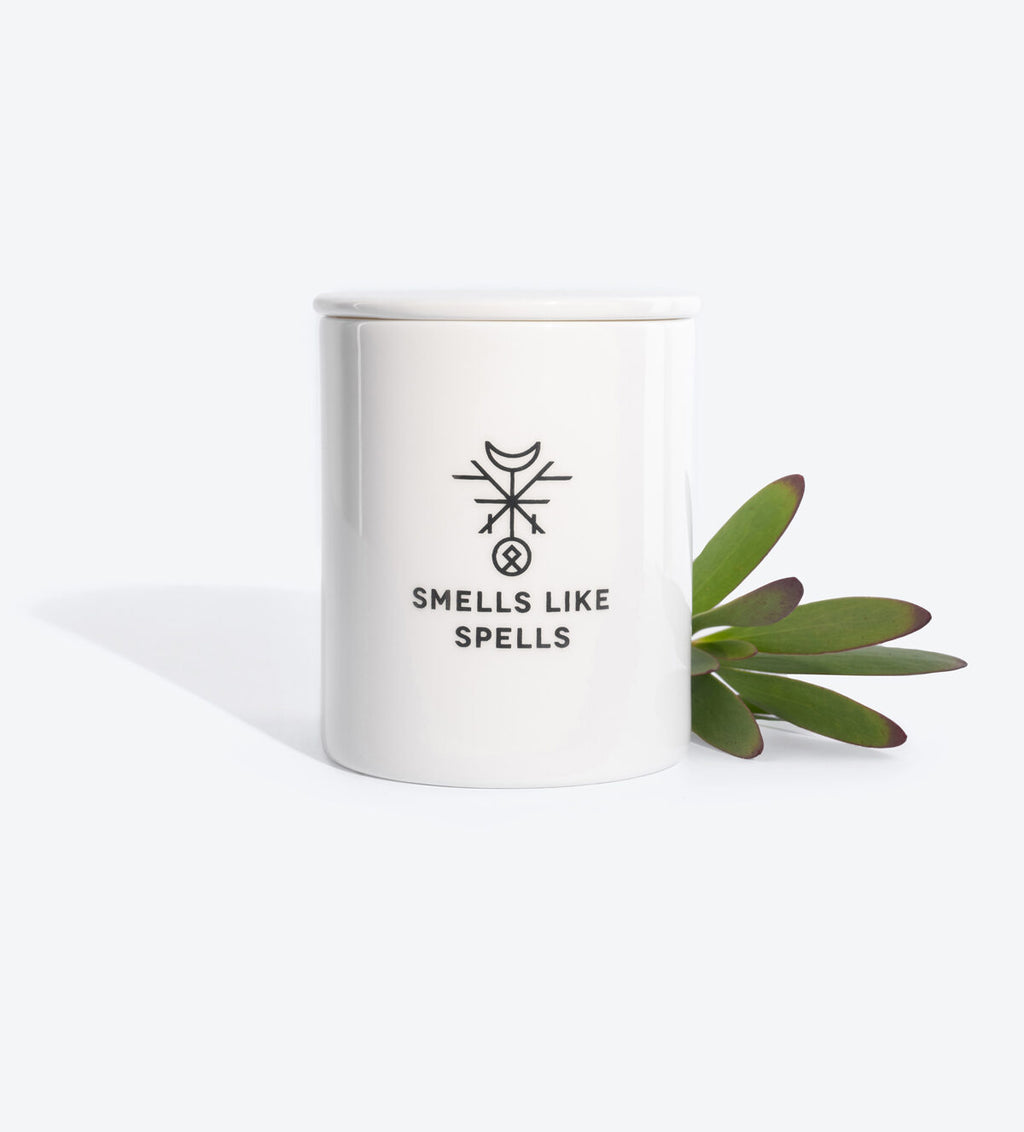 elegant porcelain vessel of the hierophant candle with its tarot card and affirmation, glowing softly in ambient light