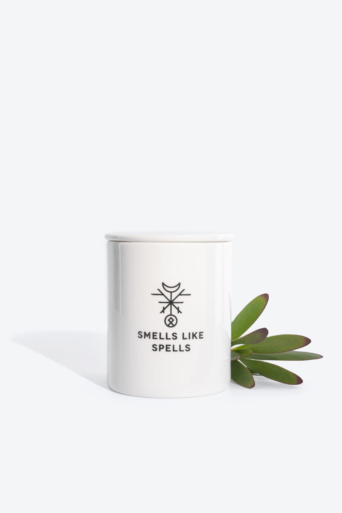 justice tarot candle glowing boldly on a dark altar with pine and juniper scent