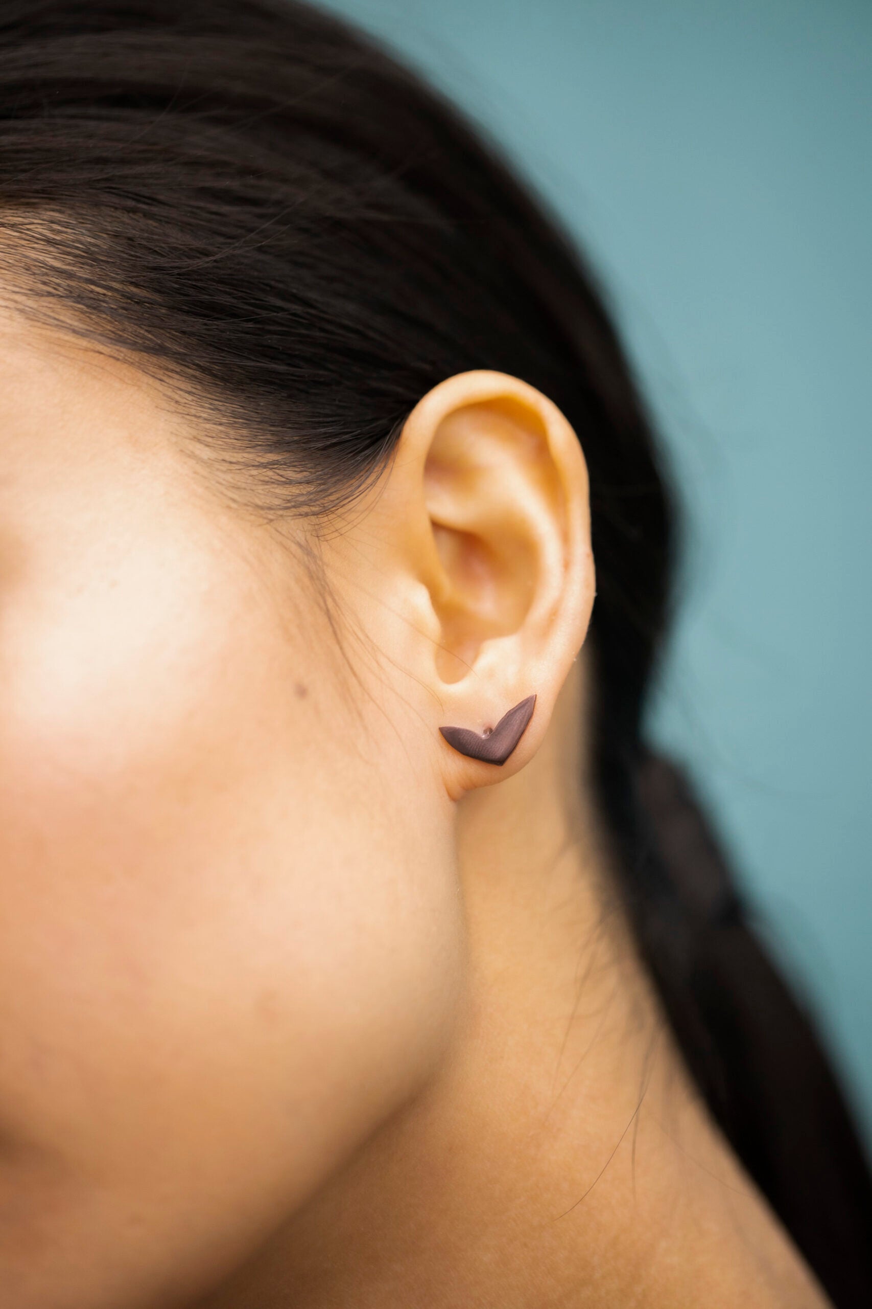 bold close-up of vola purple earrings with polished eco-steel and vibrant pvd coating