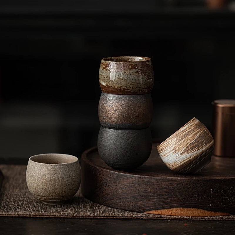 Stacked ceramic bowls on a wooden surface with a dark background at Sostter