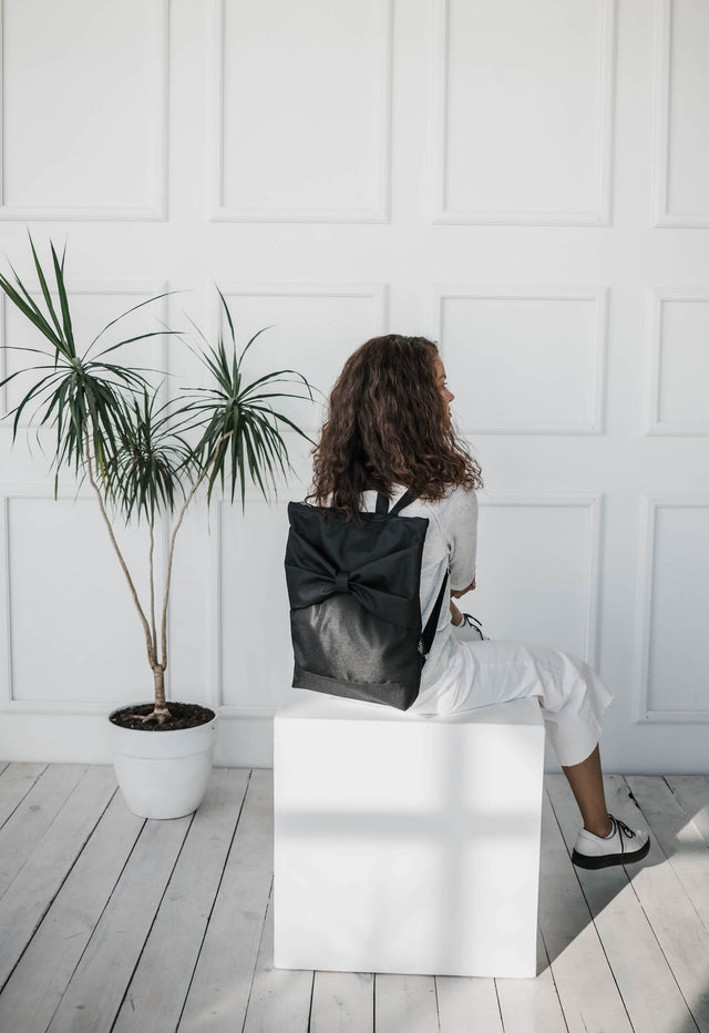 Stylish Black Bow Backpack – Chic, Functional & Waterproof by Muni at www.brixbailey.com