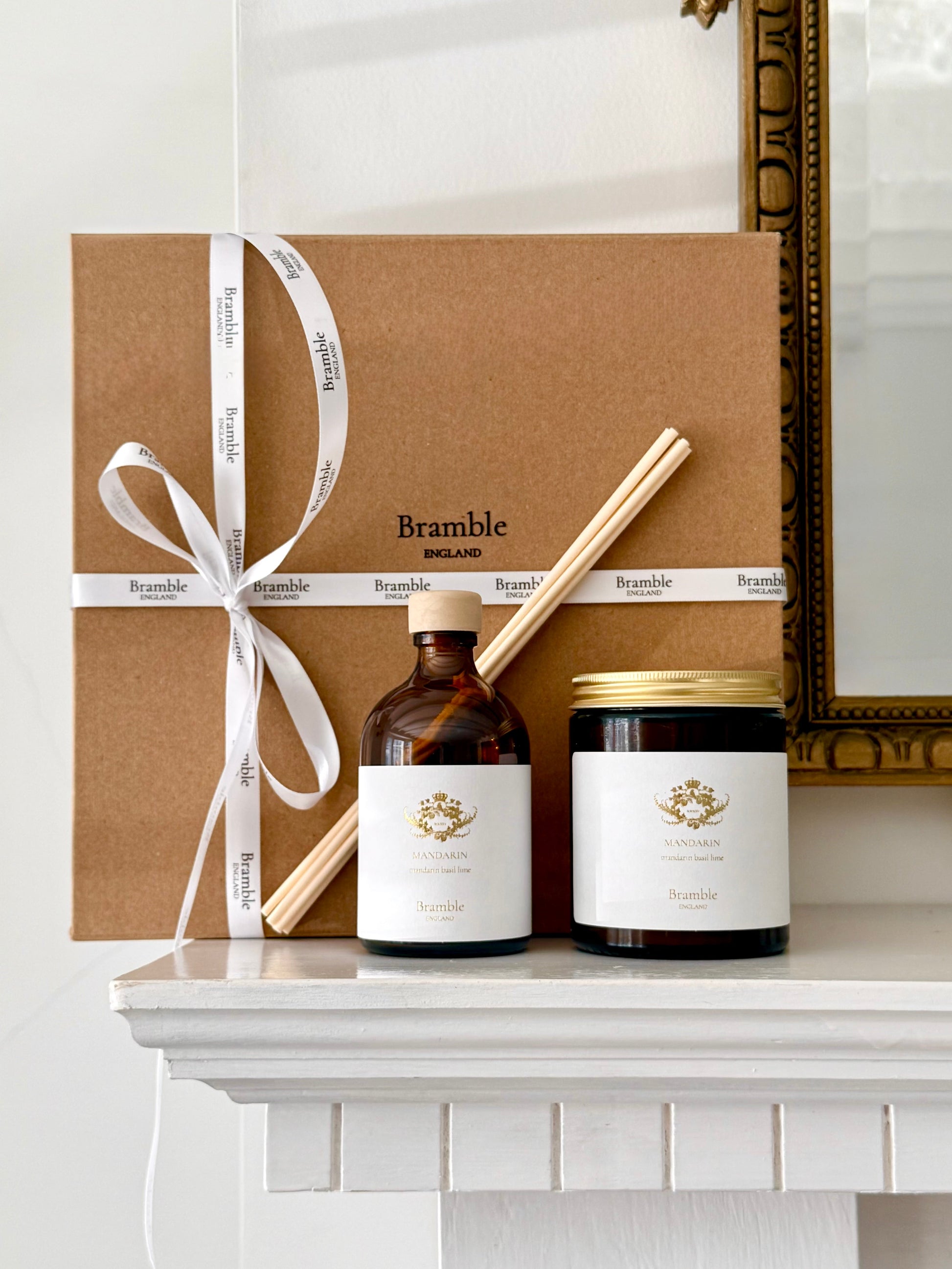 Bramble brand products including a bottle, jar, and box on a white surface with a decorative mirror in the background.