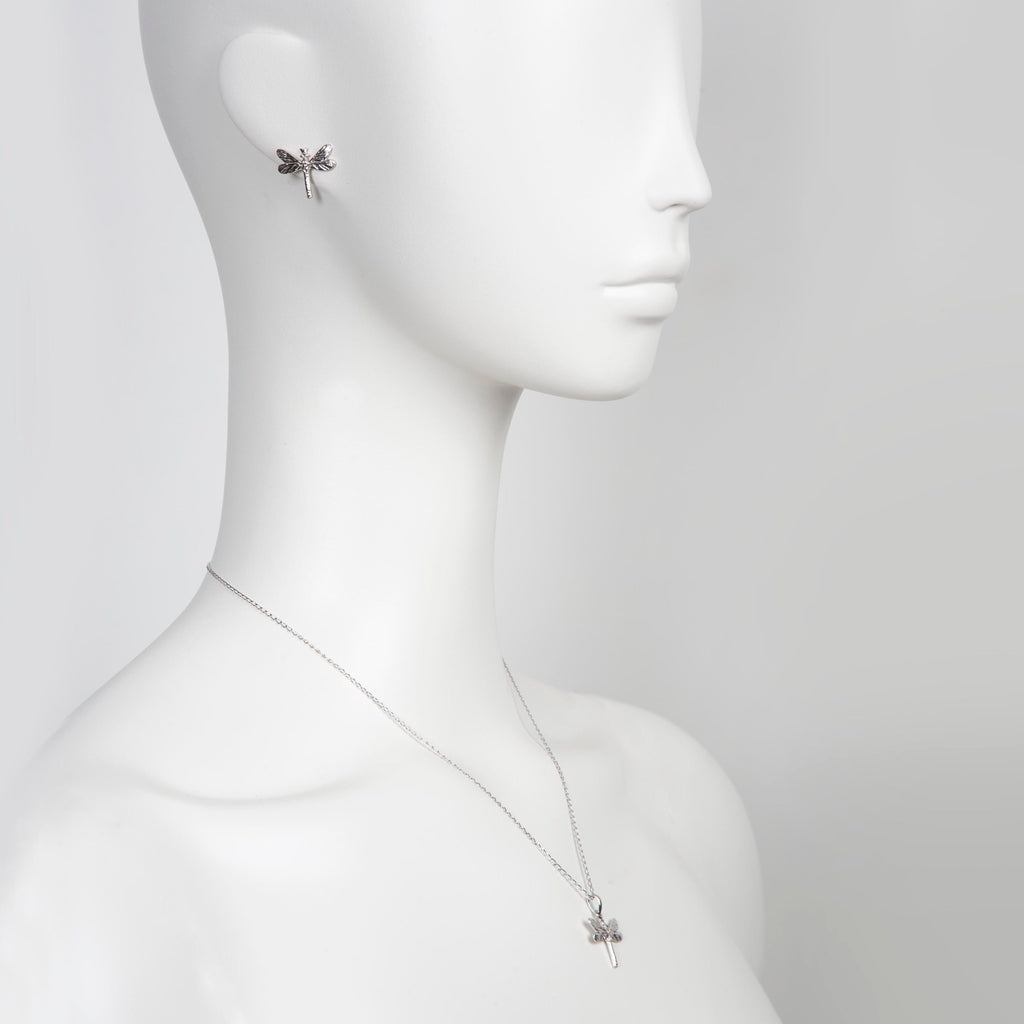 playful silver dragonfly earrings sparkling with gemstones in golden light