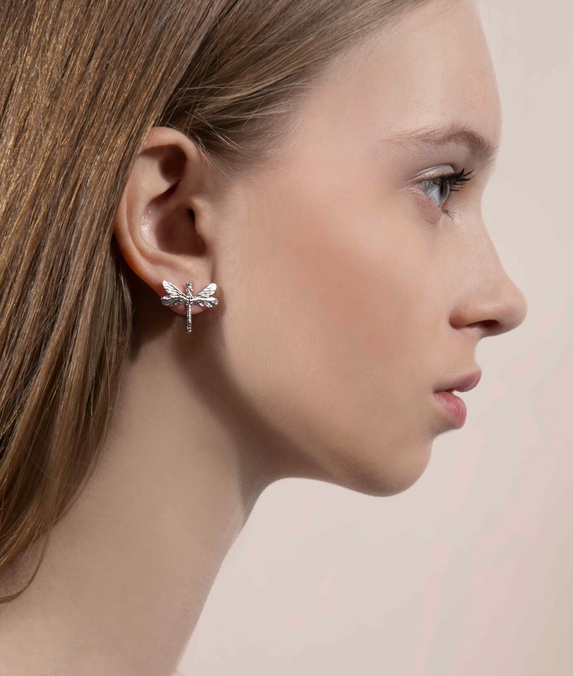 bold silver dragonfly earrings with gemstones, a confident statement piece for a stylish woman