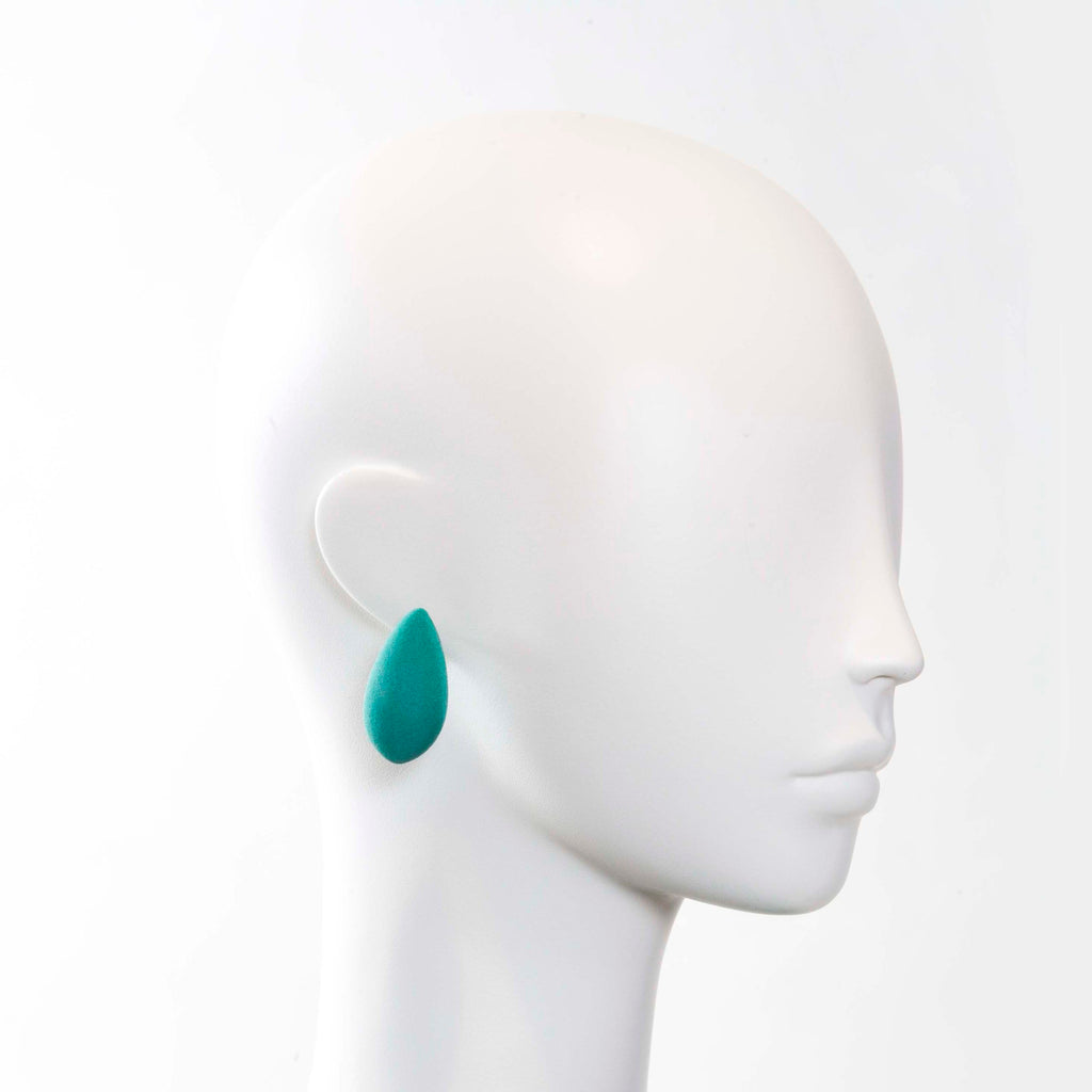 bold close-up of tanel veenre's cosmic mango earrings glowing with cosmic dust