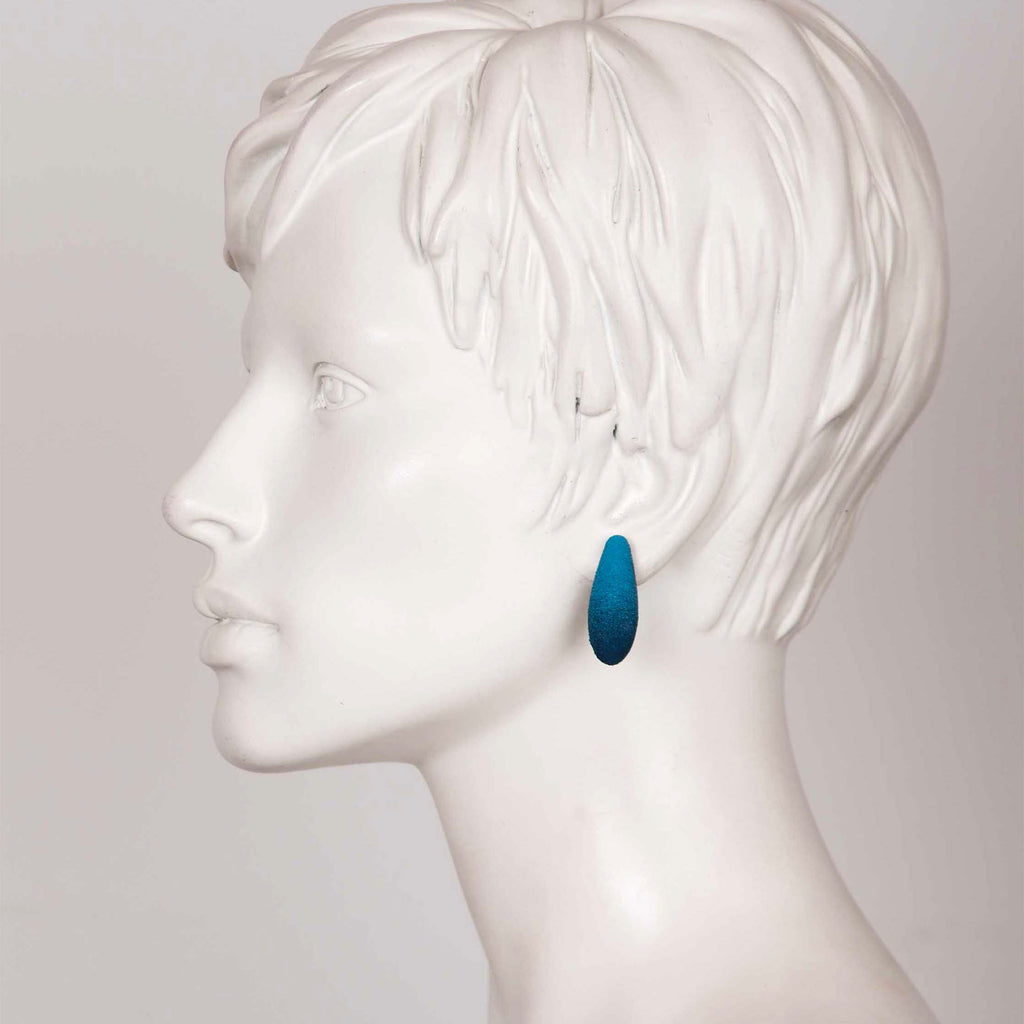 bold close-up of tanel veenre mini gooseberries earrings with cosmic dust shimmer on a dark background