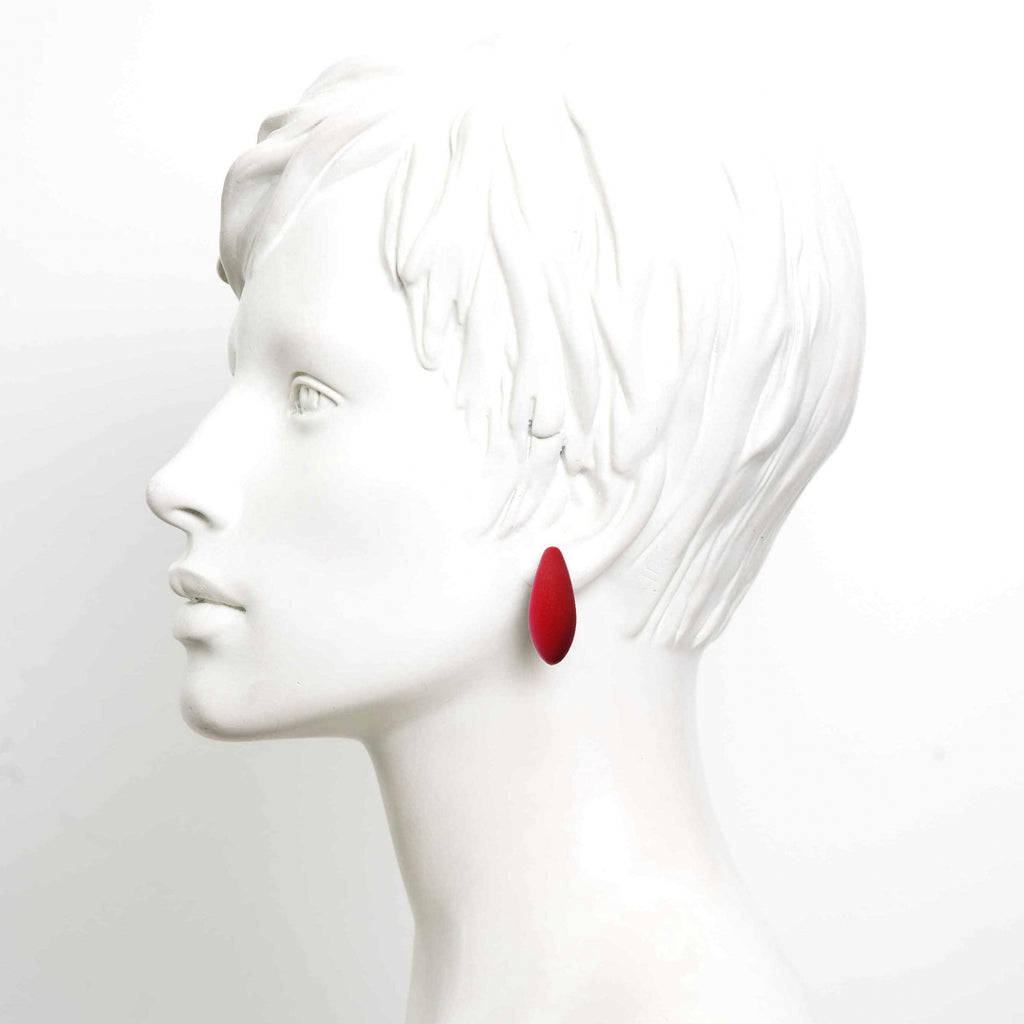 bold mini cherries earrings with cosmic dust finish on a dark background