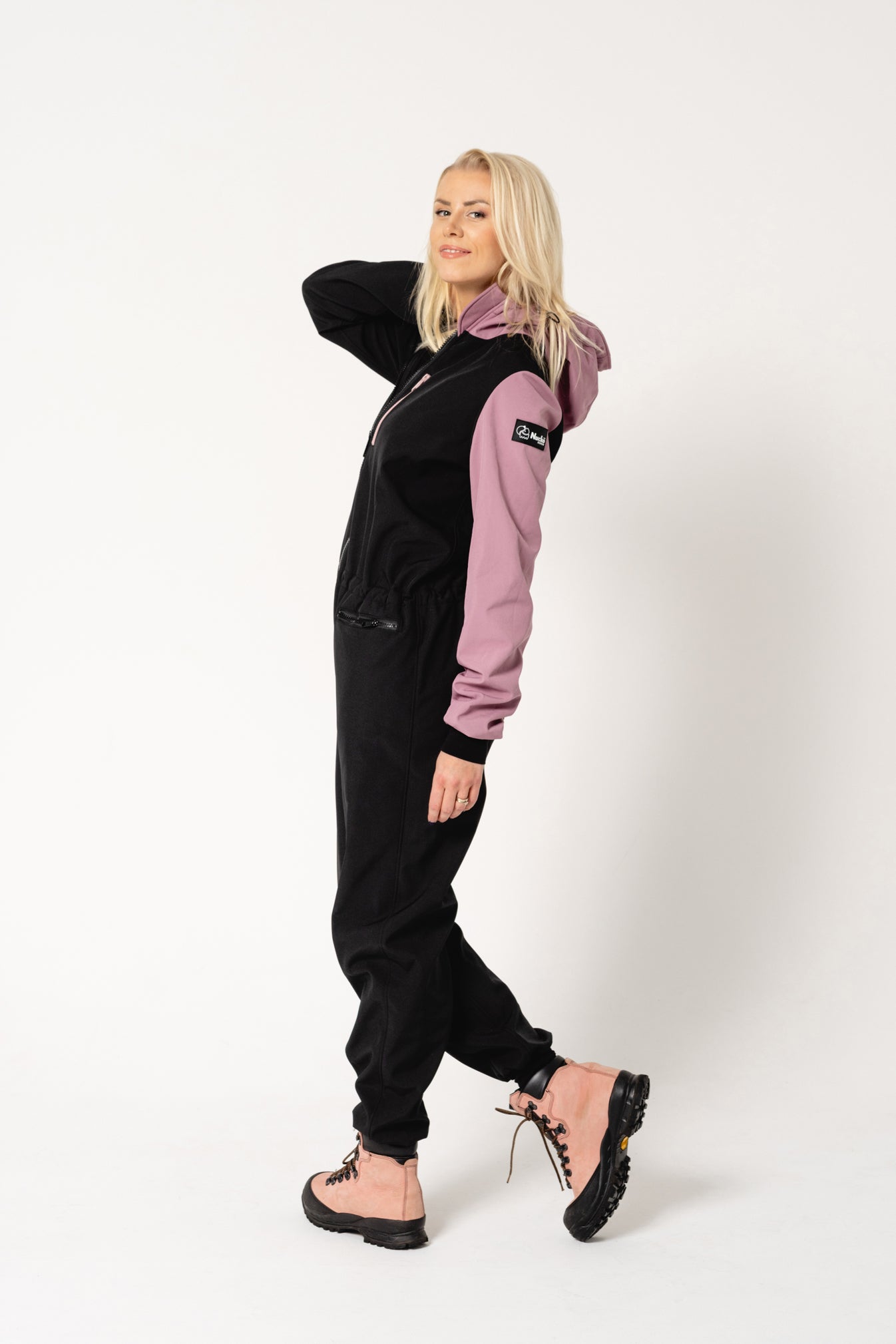 elegant child in a tailored waterproof softshell overall, ready for a refined winter adventure