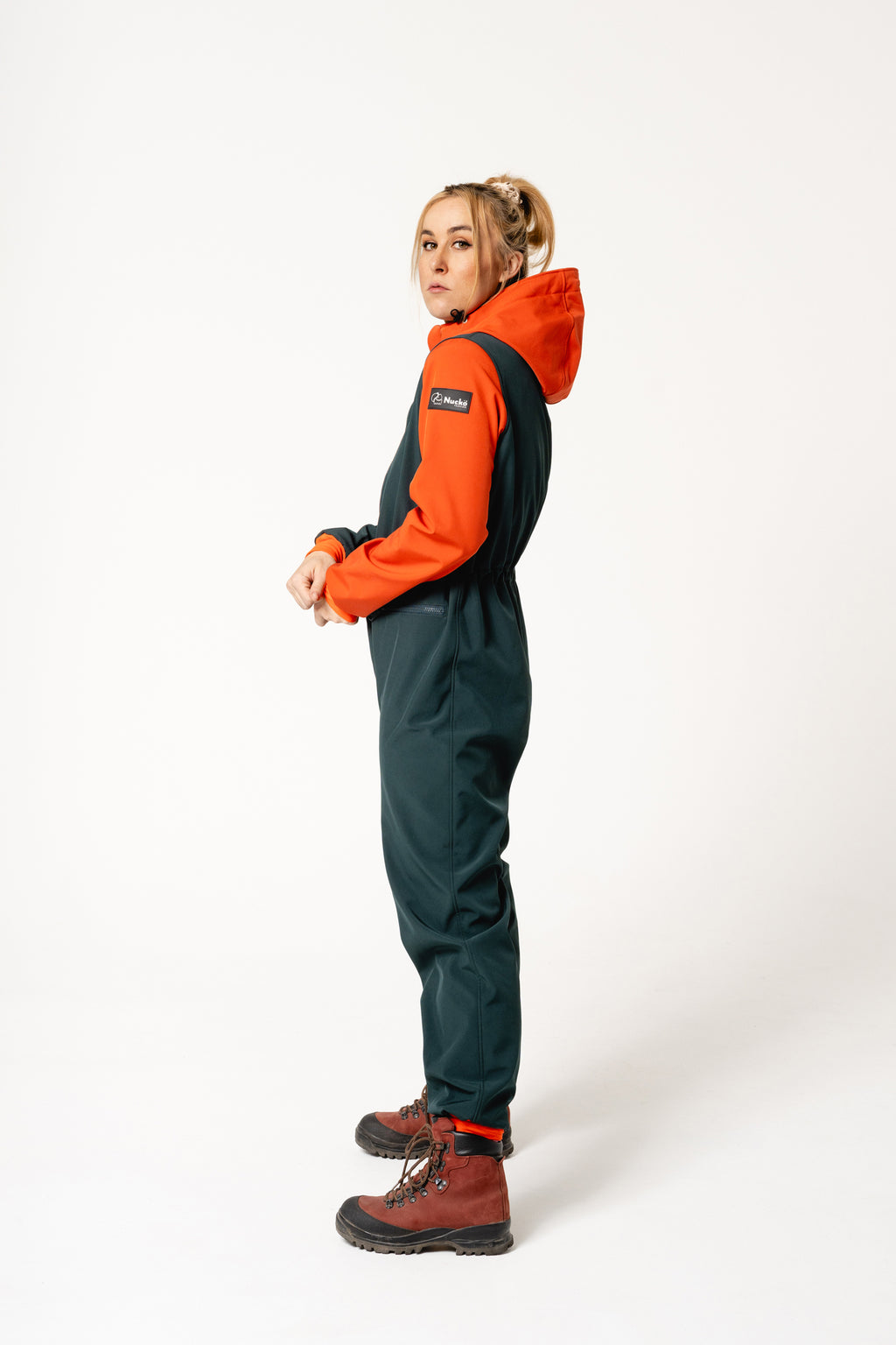 a woman in a softshell overall enjoying a gentle walk, the soft morning light highlighting its comfortable and adjustable fit