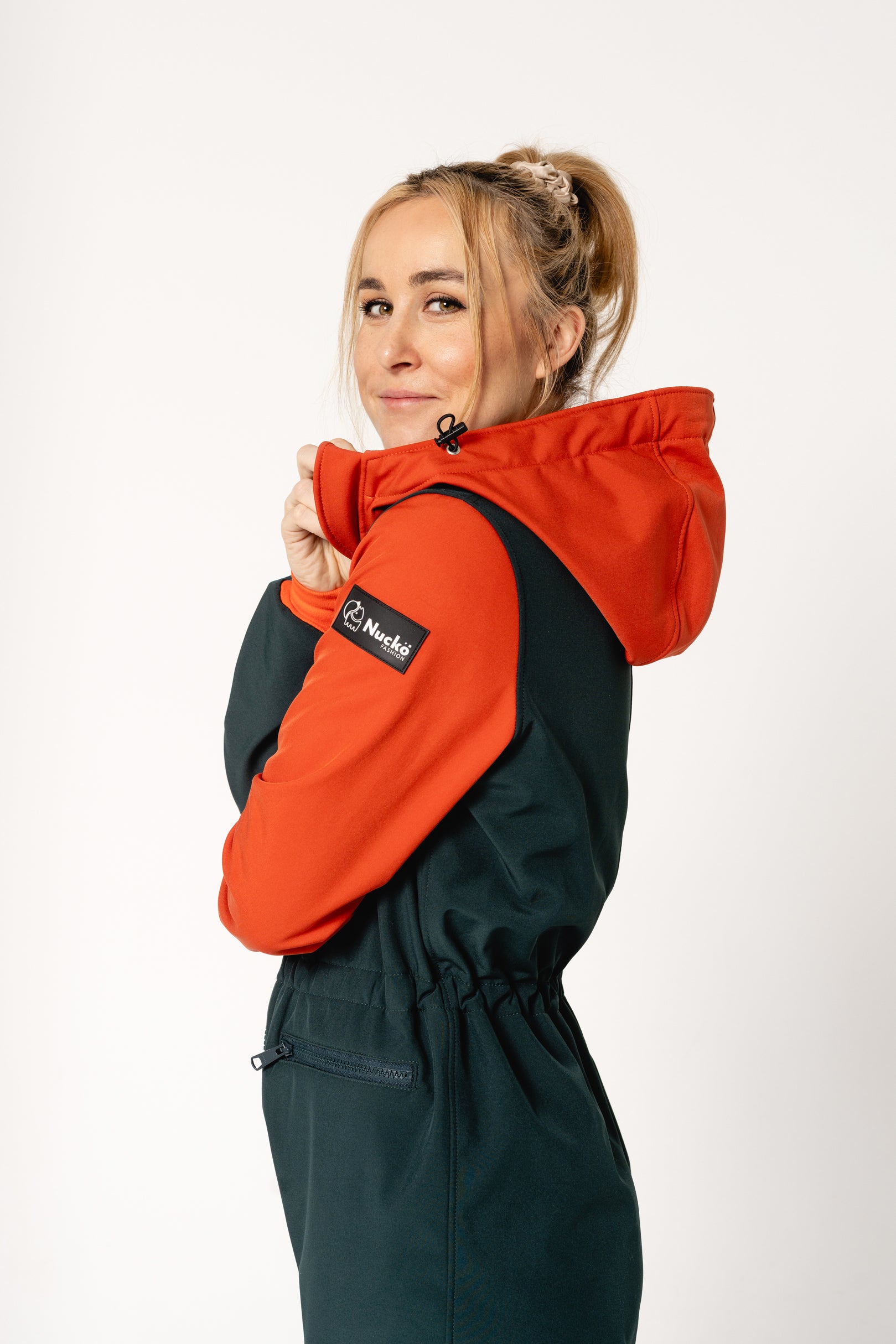 elegant woman in a refined softshell overall, tailored fit with adjustable details for a sophisticated outdoor look