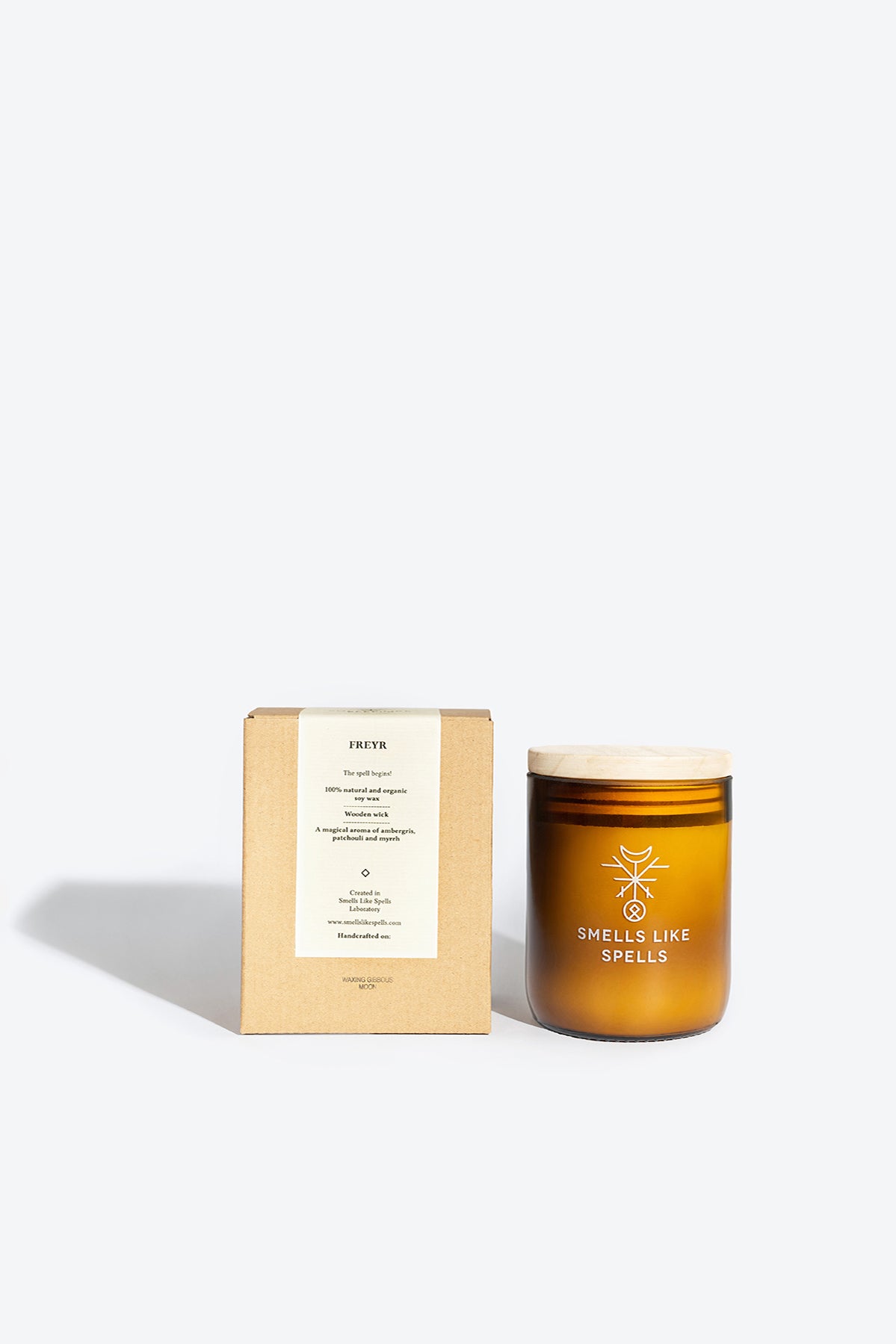 bold amber jar of freyr's fortune prosperity candle with a wooden wick, glowing confidently