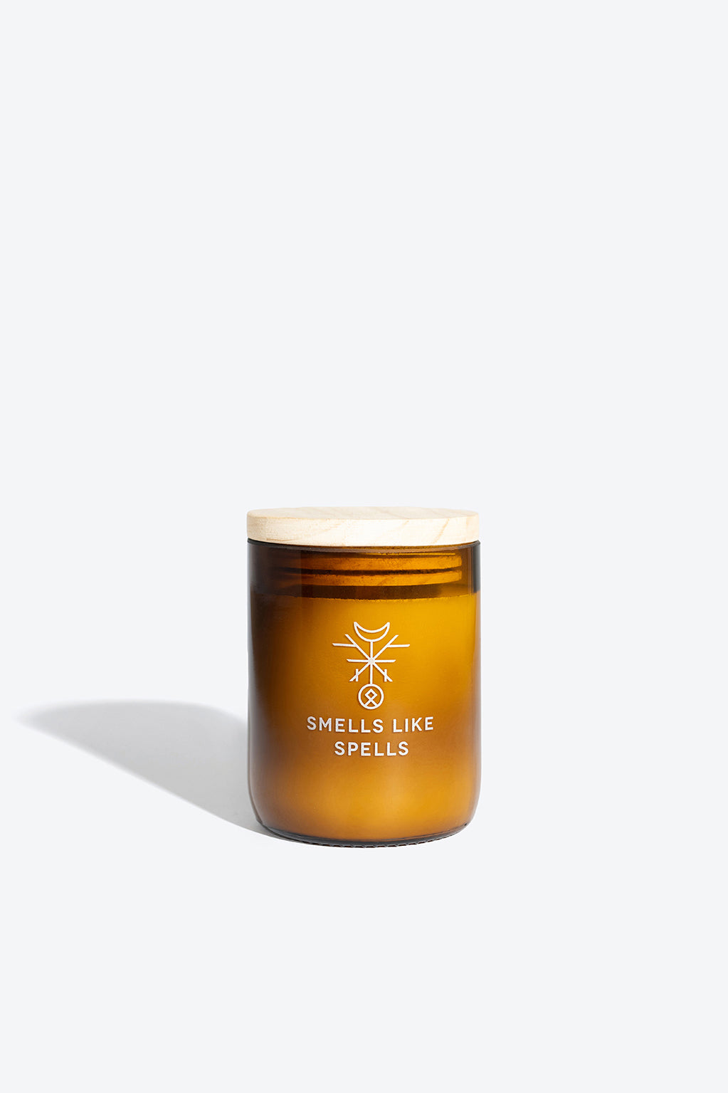 a softly lit freyr's fortune candle in an amber jar, casting a warm, comforting glow for prosperity and clarity