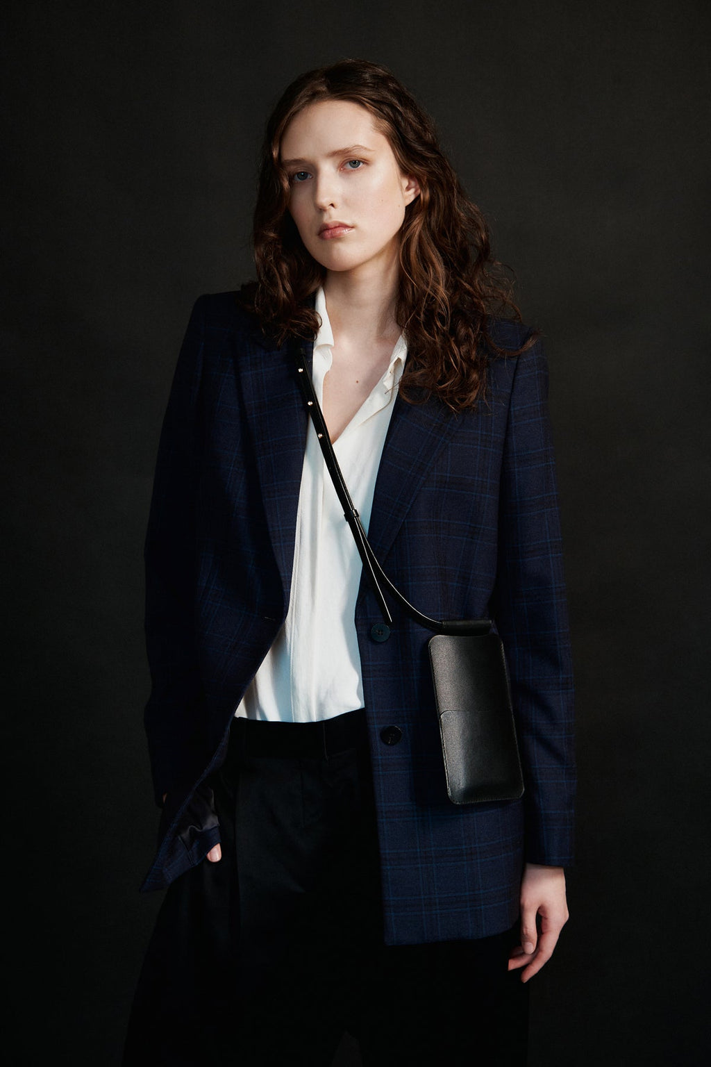bold black leather crossbody phone bag with gold hardware and card slots