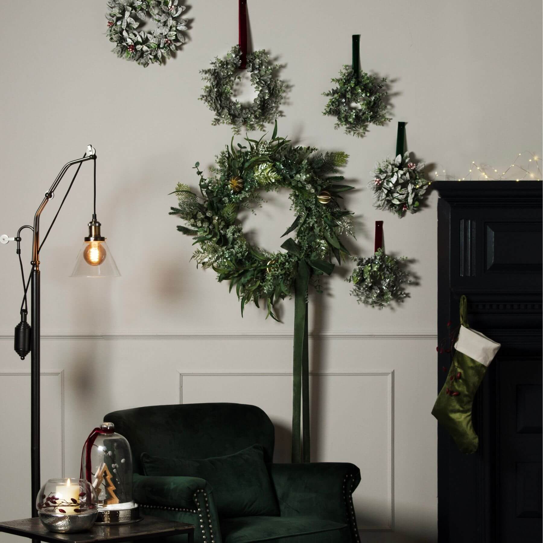 Frosted eucalyptus candle wreath with silver accents, sage green foliage, and realistic winter detailing for seasonal decor. by Sostter at brixbailey.com