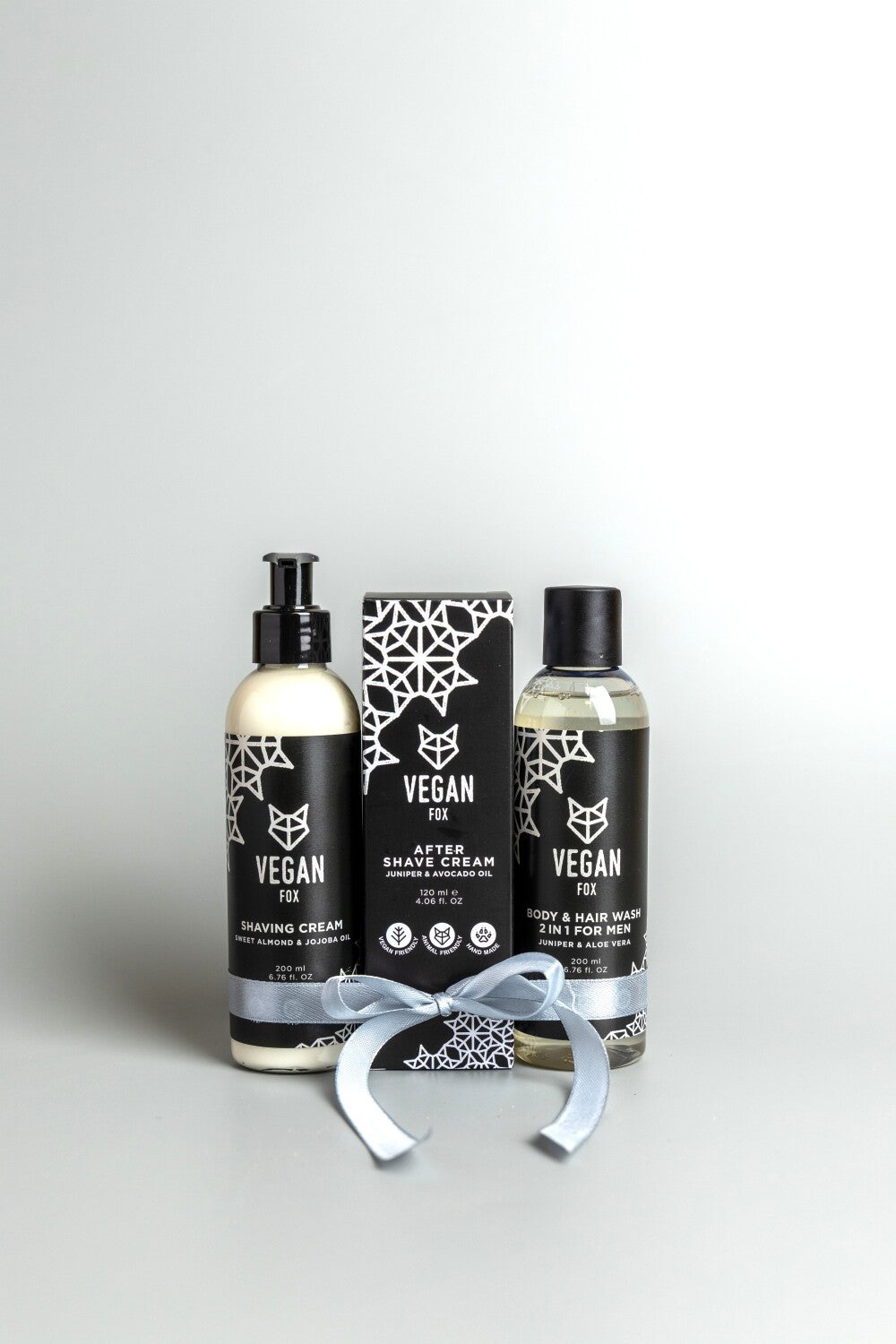 confident man holding the ultimate vegan grooming set with forest-scented products