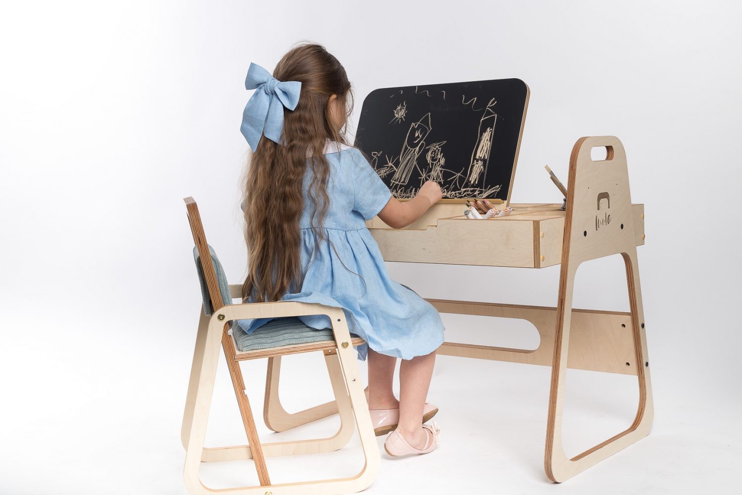 mint green julle kids chair with plush padding and smooth birch wood armrests
