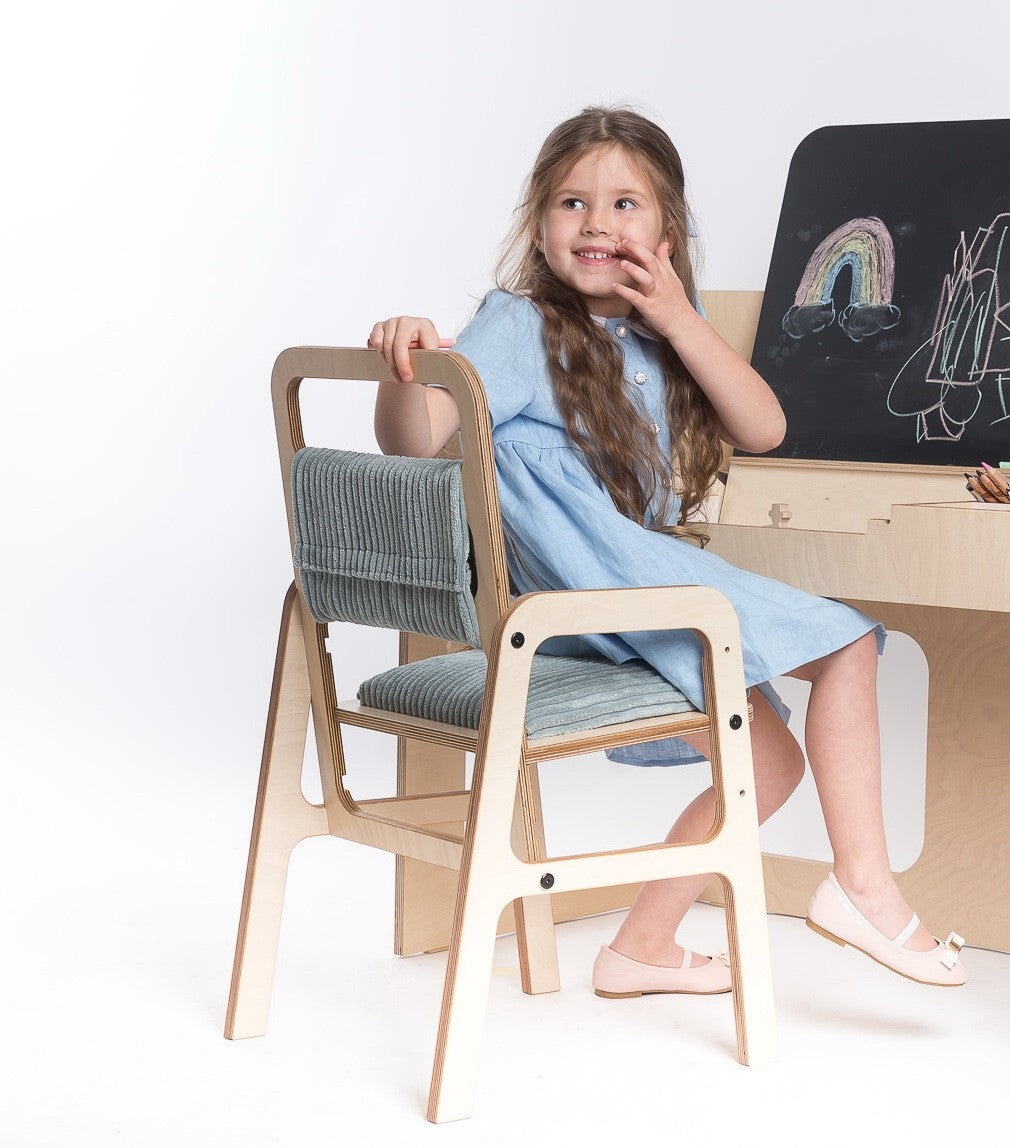 elegant mint green ergonomic children's chair with natural birch wood grain detail