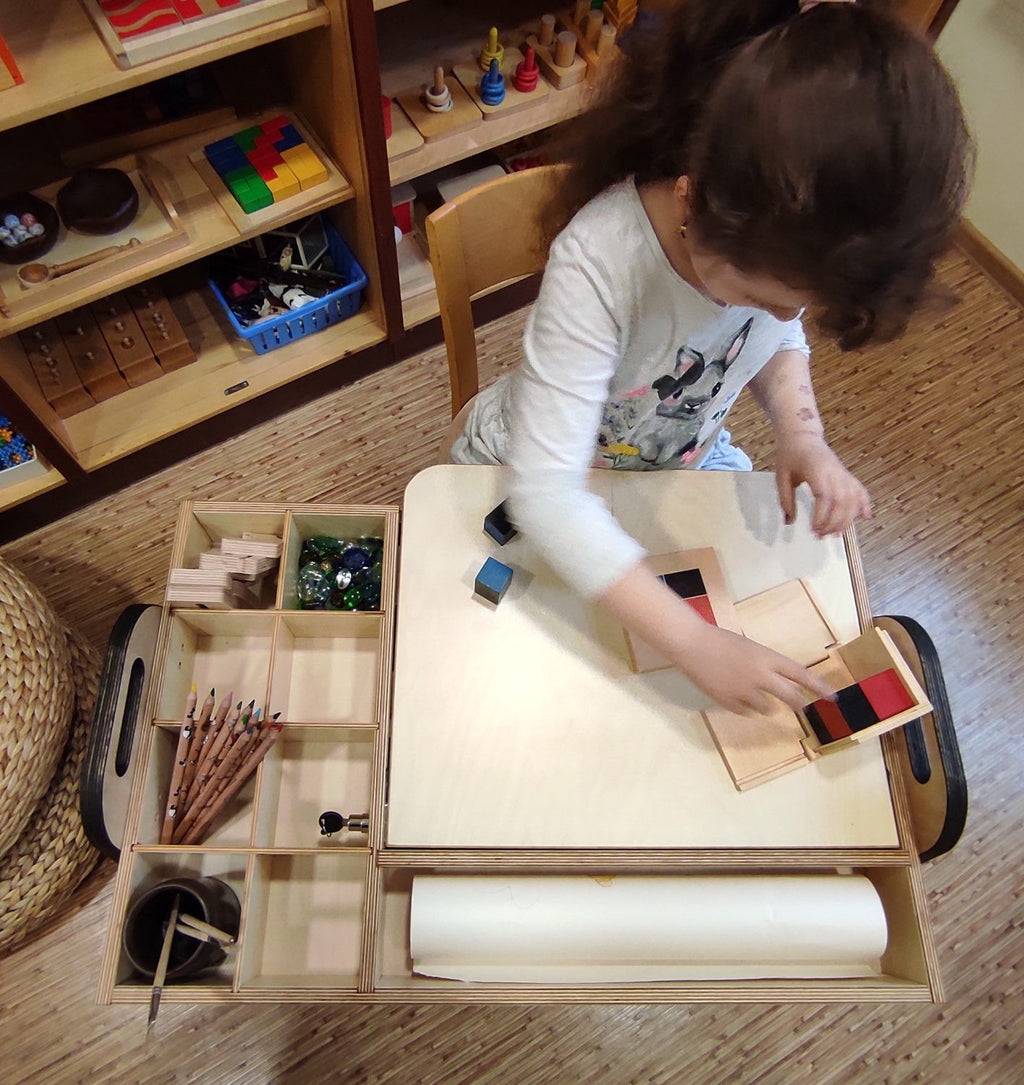cannon pink montessori table and chair set with chalkboard and paper roll in a bright, airy playroom