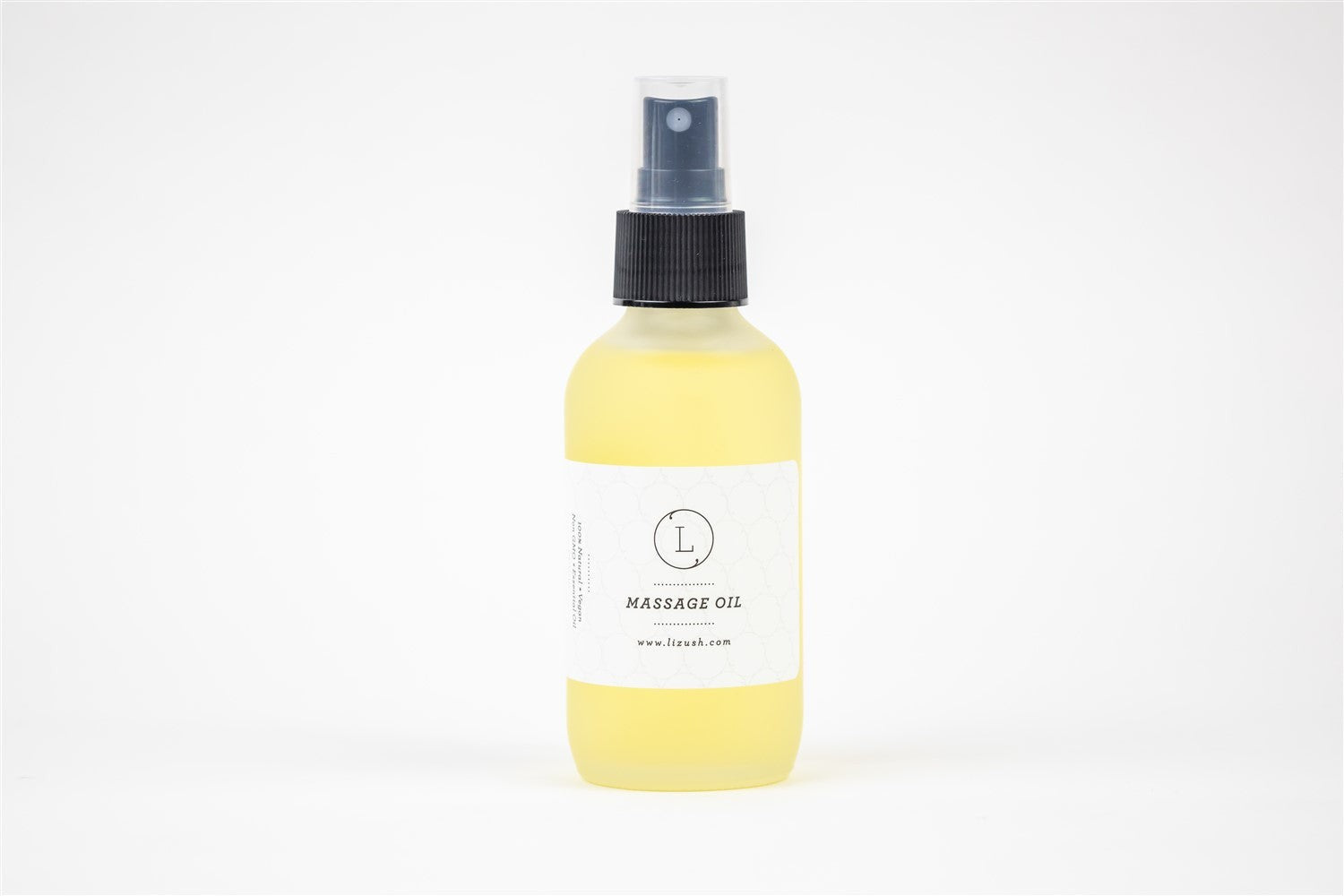 eucalyptus massage oil in frosted glass bottle resting on a soft cotton bag