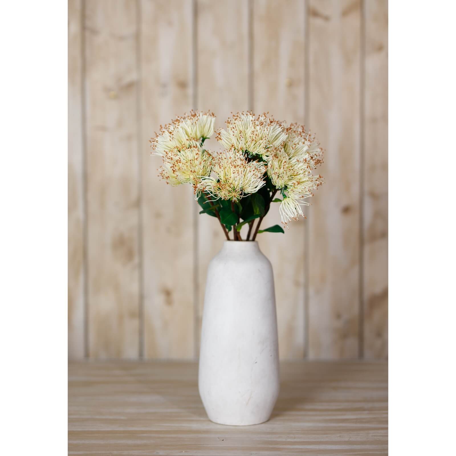 Creamy-white Protea Nitida stem with lush green leaves, lifelike plastic floral decor for elegant home arrangements. by Sostter at brixbailey.com