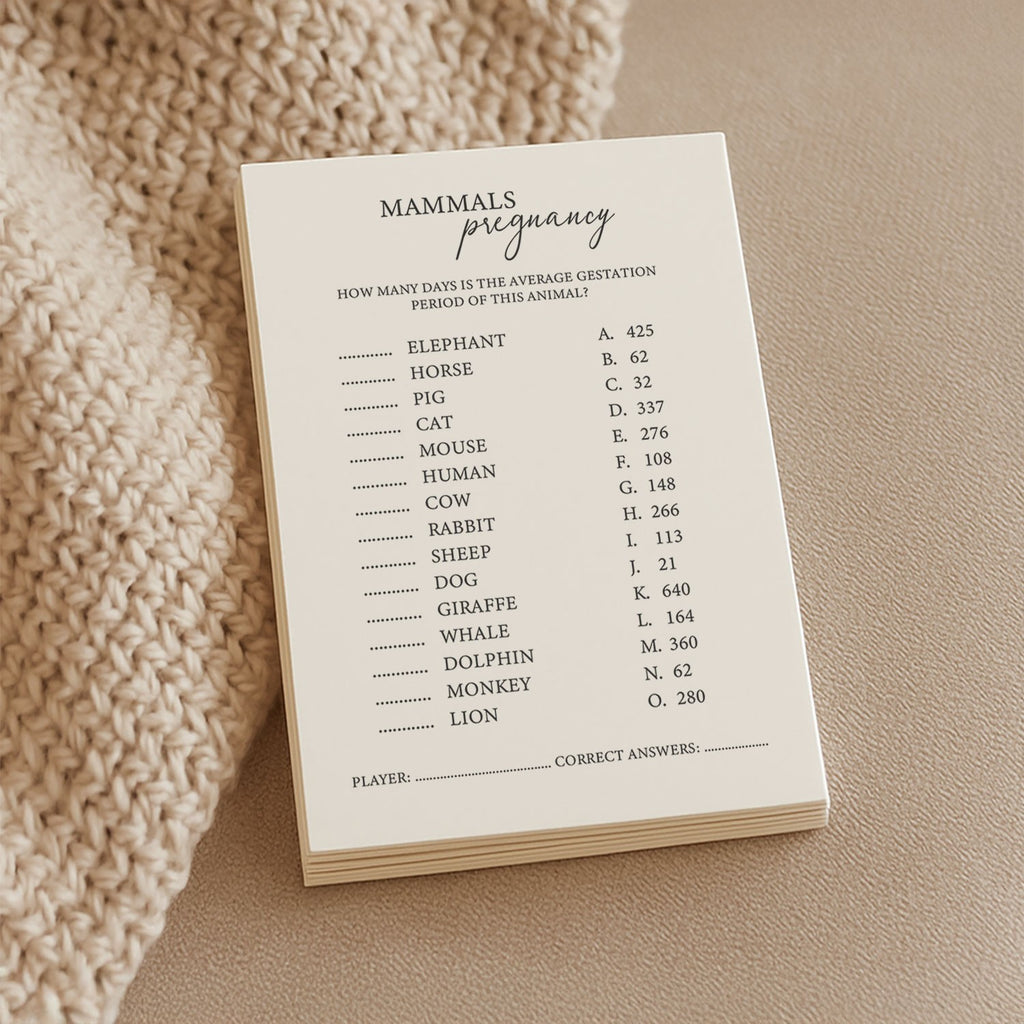 a soft-lit close-up of the mammal trivia game's luxurious cream cardstock, resting on a cozy knitted blanket