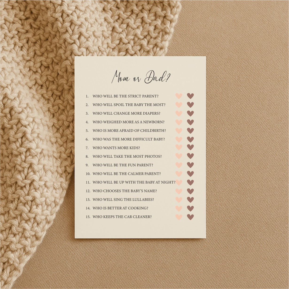 a bold close-up of baby shower game cards on a dark background, showcasing the premium cream paper