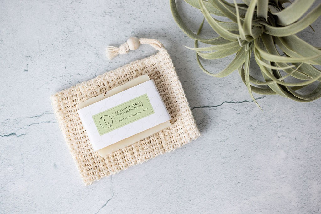 a playful gift box overflowing with eucalyptus spa products like soap and massage oil
