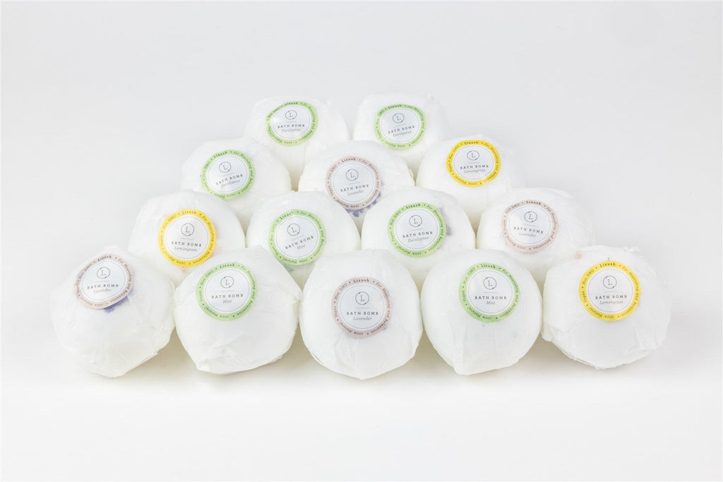 a functional close-up of a lemongrass bath bomb on wax paper, showing its natural texture and ingredients