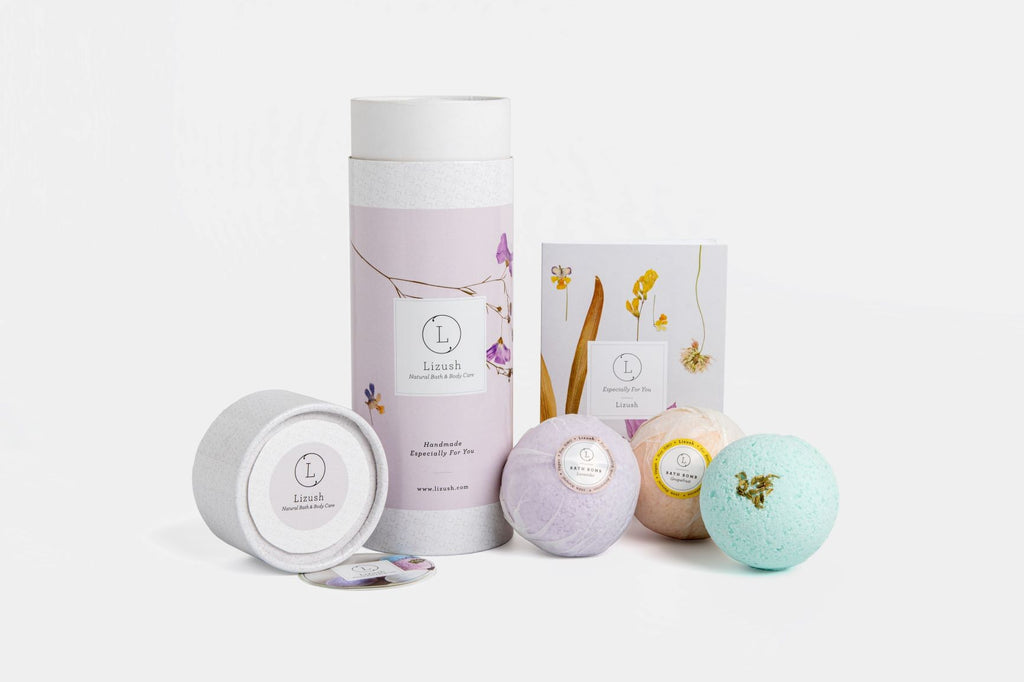 bold close-up of a vibrant lizush bath bomb trio in an elegant gift box