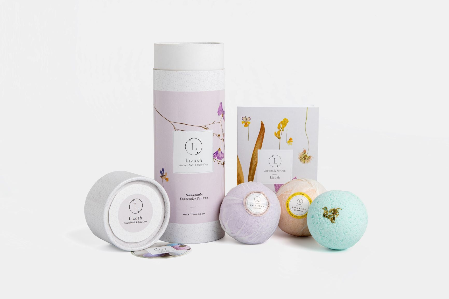bold close-up of a vibrant lizush bath bomb trio in an elegant gift box