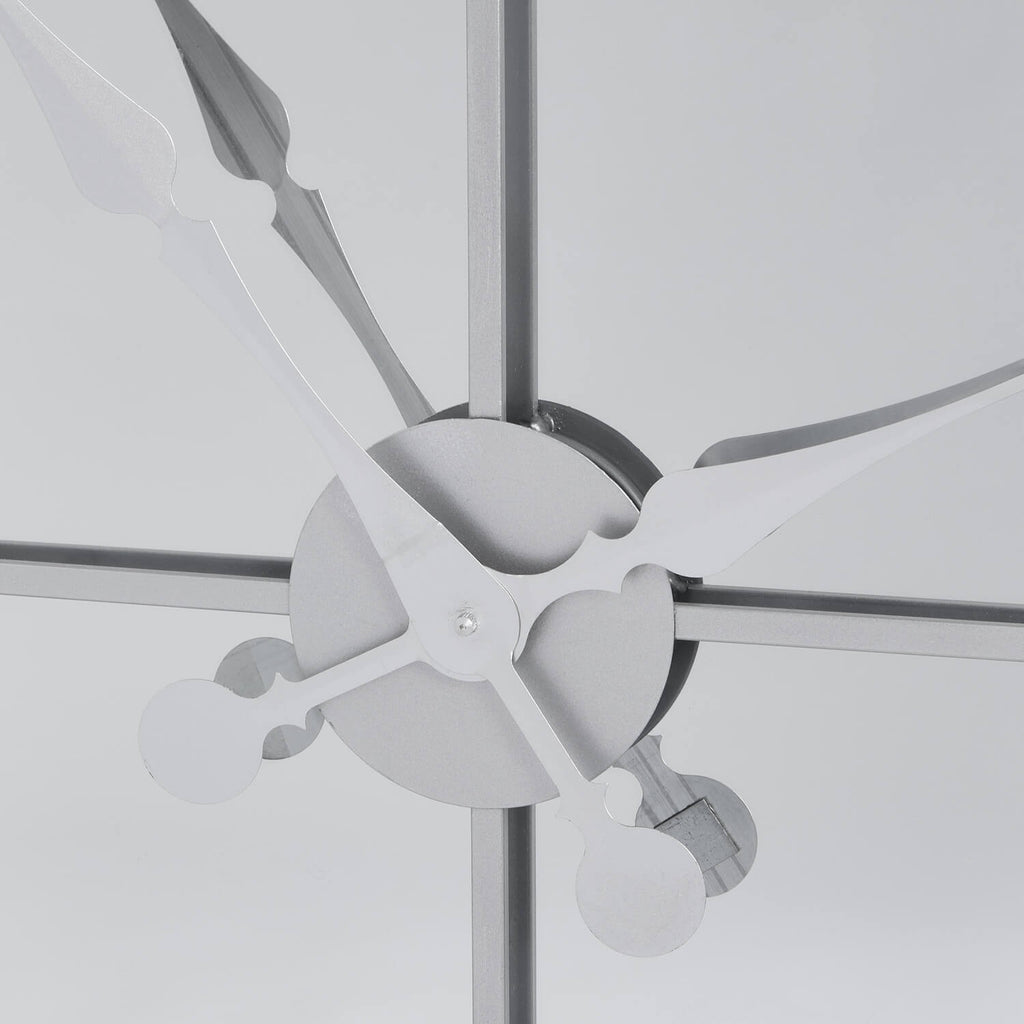 Celina mirrored wall clock with silver metal frame, modern skeleton design, and reflective glass surface by Sostter at brixbailey.com