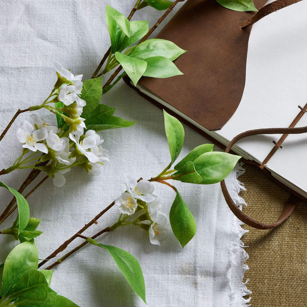 Mock orange spray with realistic glossy leaves and delicate white petals, 53-inch artificial floral stem for home decor by Sostter at brixbailey.com